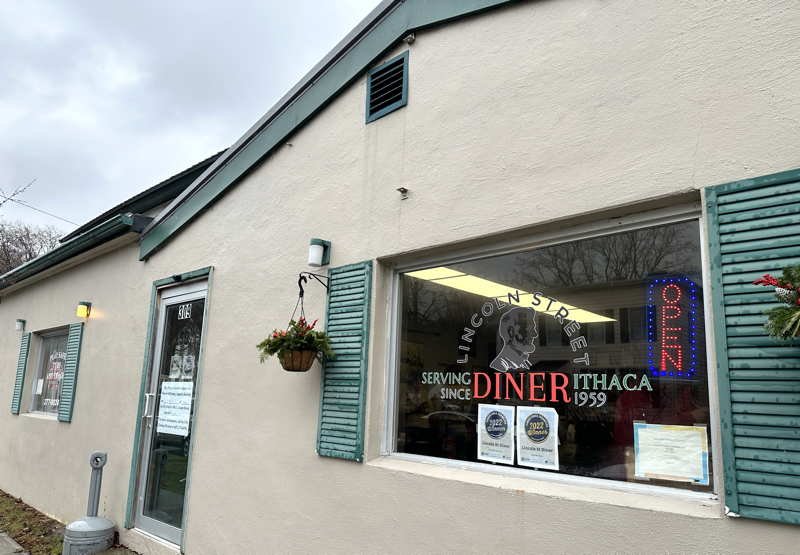 Cozy diner booths with simple tabletop settings.